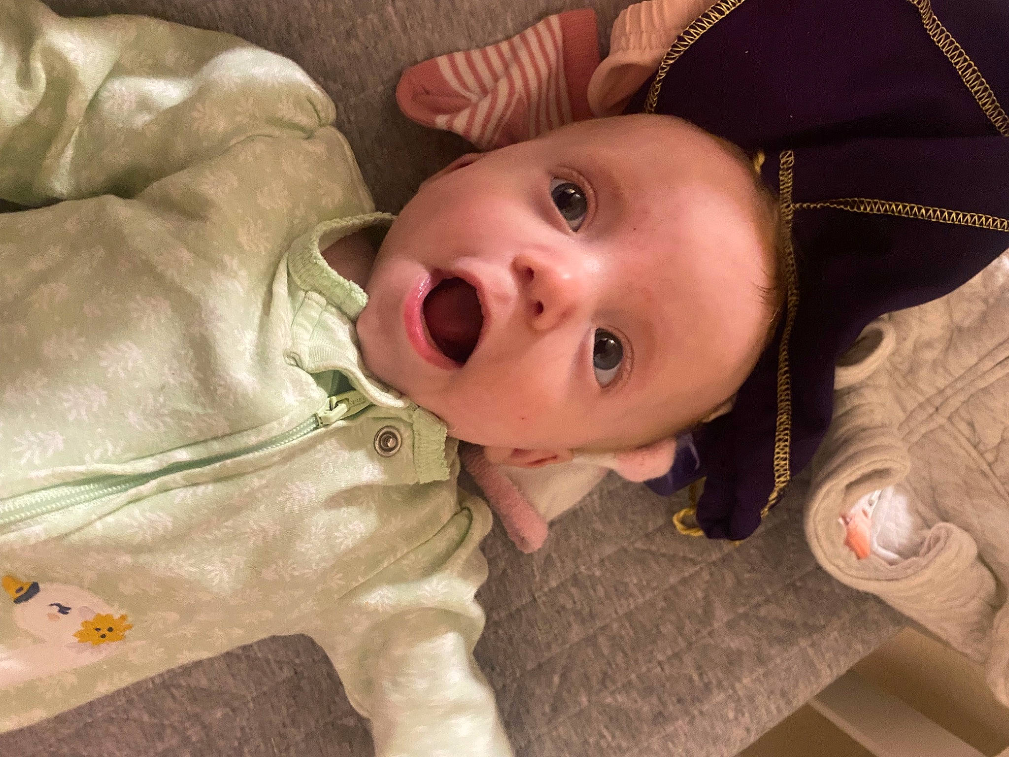 Scarlett is registered to the contest to win money with this photo: baby, baby_products, baby_toddler_clothing, cheek, eye, eyebrow, eyelash, flooring, grass, hat, head, human_body, iris, lip, mouth, nose, person, sleeve, smile, surprise