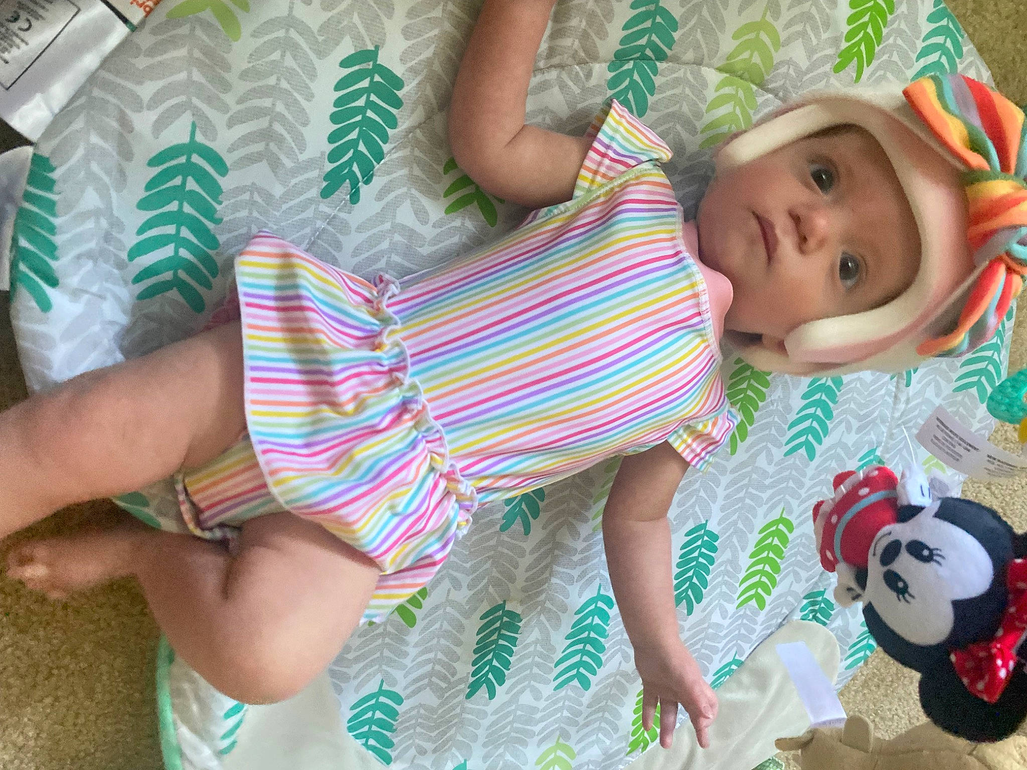 Scarlett is registered to the contest to win money with this photo: arm, baby, baby_products, baby_toddler_clothing, child, comfort, fun, green, hand, happy, head, headwear, linens, pattern, person, pink, play, room, skin, thigh