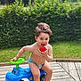 Adam a rejoint le concours — aidez-le/la à gagner de superbes lots ! toddler, child, diaper, toy_car, watermelon, outdoor, grass, hedge, summer, barefoot, play, cute, fun, greenery, wooden_deck, happy, food, fruit, sitting, nature