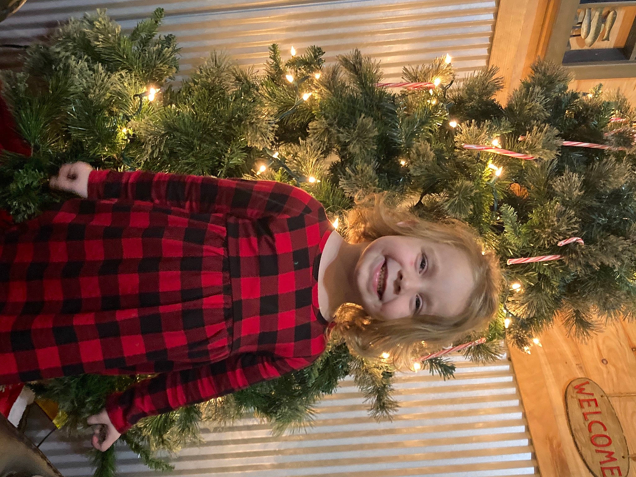 Emma joined the competition — help win amazing prizes! christmas, christmas_decoration, christmas_eve, christmas_ornament, christmas_tree, event, fun, happy, holiday, holiday_ornament, human_body, joy, light, ornament, pattern, person, plaid, plant, smile, tartan