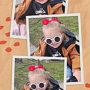Drailee is registered to the contest to win money with this photo: child, girl, sunglasses, red_bow, jacket, hoodie, jeans, bracelet, blanket, outdoor, grass, bench, smiling, happy, portrait, casual_clothing, cute, fashion, playful, daylight