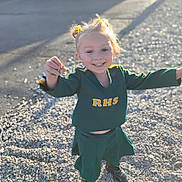 Drailee is registered to the contest to win money with this photo: casual, cheerleader, child, cute, daylight, girl, gravel, green_uniform, happy, joyful, outdoor, person, pigtails, playful, pose, shoes, short_hair, smiling, sunlight, yellow_hair_accessories