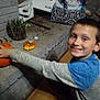 Ryder joined the competition — help win amazing prizes! child, boy, smile, pumpkin, brick_hearth, indoor, clothing, sitting, face, hands, toy, plaid_pants, gray_sleeve, blue_shirt, wood_floor, box, basket, miscellaneous, home, happy