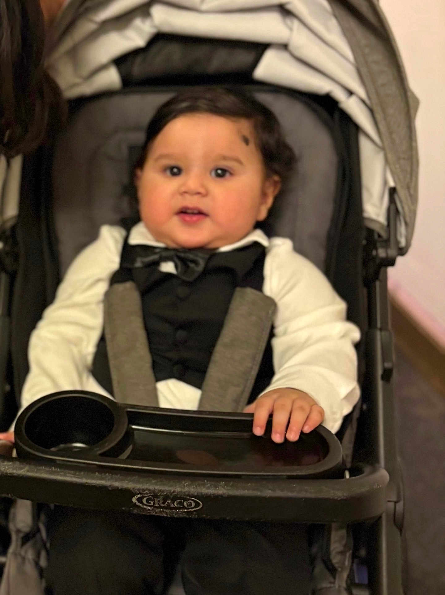 Shiven joined the competition — help win amazing prizes! baby, child, tuxedo, bow_tie, stroller, graco, black_hair, white_shirt, formal_wear, infant, cute, portrait, seated, hand, indoor, face, clothing, person, baby_boy, smile