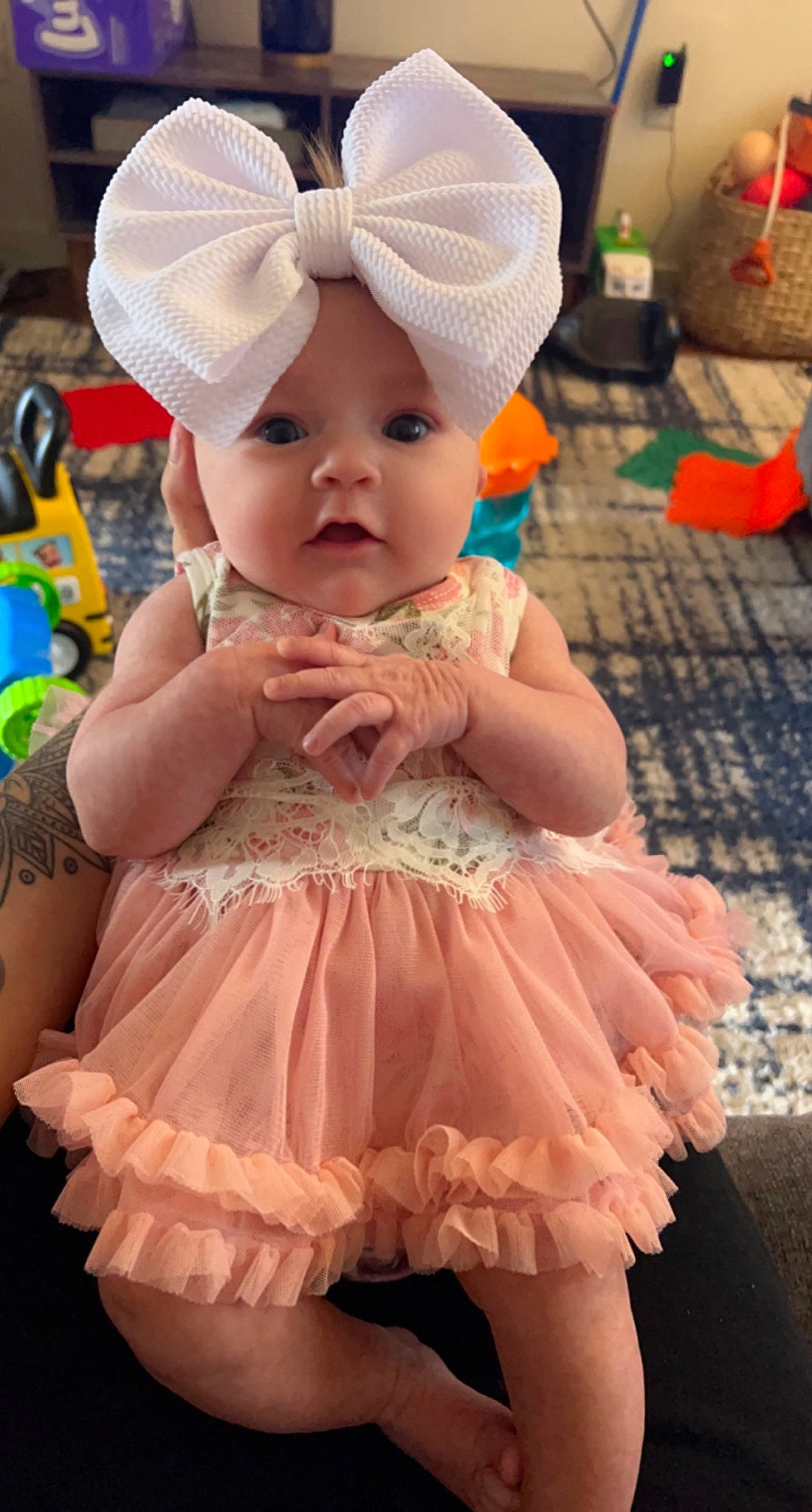 Nora is registered to the contest to win money with this photo: baby, baby_toddler_clothing, cap, child, clothing, day_dress, dress, embellishment, fashion, hat, headwear, iris, magenta, pattern, person, pink, purple, ruffle, skin, sleeve
