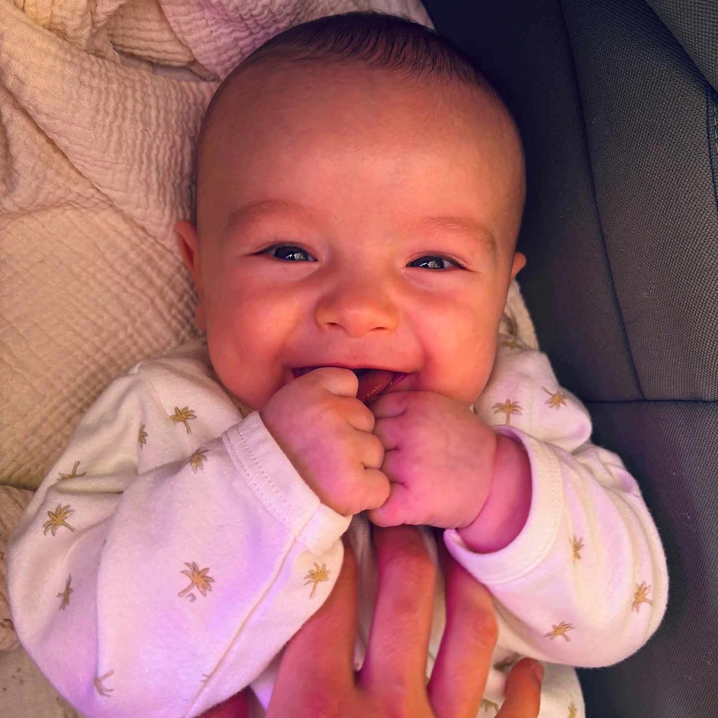 Gabriel participe au concours pour gagner de l'argent avec cette photo : baby, blanket, closeup, clothing, comfort, cute, face, fingers, hand, happy, holding, indoor, infant, person, portrait, skin, sleeve, smiling, toddler, young_child