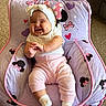 baby, carpet, child, clothing, cushioned_chair, cute, feet, happy, head, headband, indoor, infant, joyful, minnie_mouse, person, pink_pants, purple, sitting, smiling, young_child