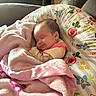 Kinsley is registered to the contest to win money with this photo: baby, blanket, child, clothing, comfort, cozy, cushion, cute, face, floral_pattern, head, home, indoors, infant, peaceful, person, pink, resting, sleeping, soft_texture