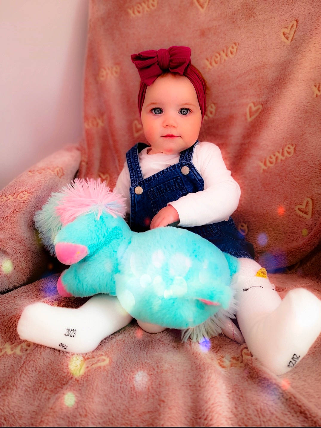 Emily participe au concours pour gagner de l'argent avec cette photo : baby_toddler_clothing, baby_toys, cheek, child, collectable, doll, eye, eyelash, fashion_accessory, fur, headwear, magenta, peach, person, pink, purple, sitting, skin, textile, toy