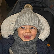 Arman a rejoint le concours — aidez-le/la à gagner de superbes lots ! baby, child, smiling, hat, scarf, winter_clothing, stroller, cozy, warm, pom_pom, bundle, happy, face, portrait, indoor, jacket, blanket, cute, person, infant