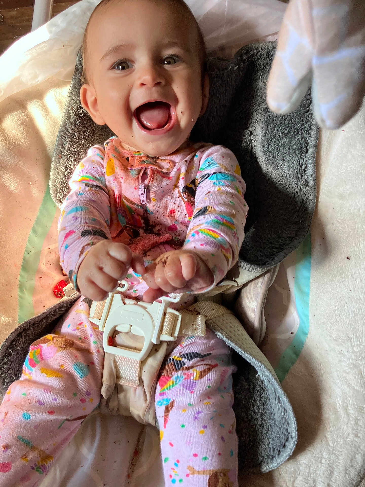 Ophelia is registered to the contest to win money with this photo: baby, child, smiling, happy, pajamas, colorful_clothing, cushion, seat, harness, baby_seat, infant, playful, indoor, face, hands, feet, closeup, joy, cute, messy