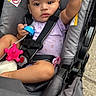 Ivey joined the competition — help win amazing prizes! baby, child, closeup, concrete, cute, expression, face, gray, hand_raised, infant, outdoor, pacifier, person, purple_onesie, safety, seat_belt, sitting, stroller, toy, warning_label