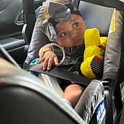 Ivey is registered to the contest to win money with this photo: baby, bracelet, car_interior, car_seat, child, clothing, cute, hand, headband, infant, looking_away, plush_toy, portrait, safety, seat, seat_belted, seatbelt, soft_toy, toy, window