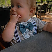 Alistair Thatcher joined the competition — help win amazing prizes! baby, child, toddler, portrait, face, smiling, sitting, bow_tie, suspenders, shirt, hand, finger, restaurant, table, outdoor, woodland, trees, string_lights, daylight, candid