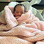 newborn, baby, blanket, pink, smile, face, infant, baby_seat, soft_toys, indoor, cozy, wrapped, cute, resting, child, young, warm, furniture, comfort, sleepy
