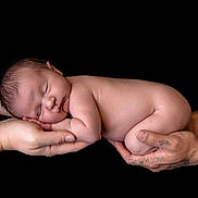 Jaxson is registered to the contest to win money with this photo: newborn, baby, sleeping, hands, tattoos, skin, infant, portrait, black_background, peaceful, closeup, naked, cute, human, parent, care, love, resting, soft, tiny