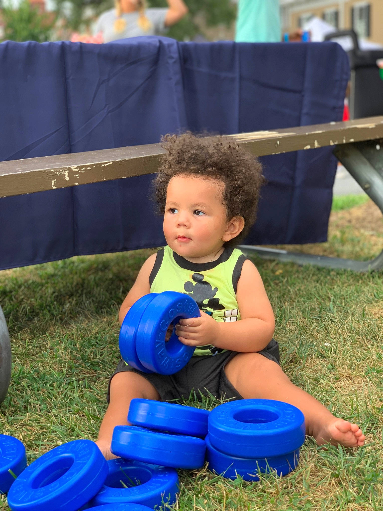 Jayvion is registered to the contest to win money with this photo: blue, bucket, child, city, electric_blue, event, fun, games, grass, happy, lap, leisure, people_in_nature, person, plastic, play, recreation, sitting, soil, toddler