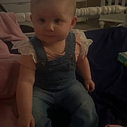 Serenity joined the competition — help win amazing prizes! baby, blanket, casual_wear, child, clothing, cozy, crib, cute, cute_baby, denim_overalls, furniture, home, indoor, infant, person, pink_shoes, portrait, sitting, soft_lighting, young_child