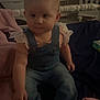 baby, blanket, casual_wear, child, clothing, cozy, crib, cute, cute_baby, denim_overalls, furniture, home, indoor, infant, person, pink_shoes, portrait, sitting, soft_lighting, young_child