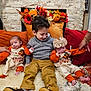 child, baby, infant, thanksgiving, holiday, family, cozy, rug, fireplace, decor, pumpkins, flowers, smile, clothing, sitting, indoor, cute, warmth, hand, portrait