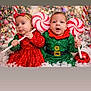 Melania is registered to the contest to win money with this photo: baby, infant, christmas, holiday, festive, decorations, lollipop, red_dress, green_outfit, sparkle, cute, snow, headband, celebration, happy, smile, child, toddler, indoors, portrait