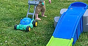 Ashten joined the competition — help win amazing prizes! toddler, child, grass, outdoor, toy, slide, lawn_mower, barefoot, pacifier, necklace, summer, fence, backyard, playtime, greenery, shorts, sunlight, young_child, playground, garden