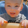 Ashten is registered to the contest to win money with this photo: child, toddler, smiling, red_hair, swing, outdoor, sunlight, happy, blue_swing, face, hands, playground, baby, clothing, person, joyful, daylight, closeup, cute, fun