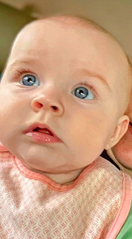 Kora is registered to the contest to win money with this photo: baby, baby_toddler_clothing, cheek, child, close_up, collar, ear, eyebrow, eyelash, happy, iris, lip, mouth, nose, person, pink, portrait_photography, skin, smile, toddler