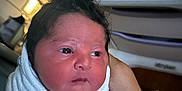 Khyaire is registered to the contest to win money with this photo: newborn, baby, blanket, hospital, hand, person, infant, face, wrapped, bed, wristband, indoors, cute, young, skin, eyes, expression, holding, parent, rest
