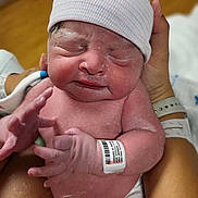 Khyaire is registered to the contest to win money with this photo: newborn, baby, infant, hospital, cap, wristband, hand, skin, person, holding, medical, birth, care, cute, fresh, tiny, human, newborn_skin, hospital_room, parent
