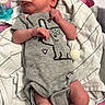 Paisley is registered to the contest to win money with this photo: newborn, baby, infant, child, hospital, hospital_bed, blanket, onesie, pacifier, medical_equipment, monitoring_wires, birth, portrait, lying_down, face, hands, feet, cartoon_clothing, indoor, nursery
