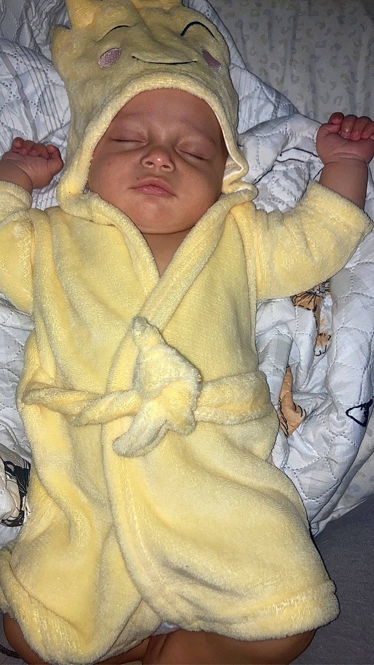 Keion is registered to the contest to win money with this photo: baby, baby_products, baby_sleeping, cheek, child, chin, comfort, eye, finger, fur, gesture, headgear, headwear, linens, person, room, skin, sleep, sleeve, thumb