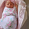 newborn, baby, swaddled, flower_headband, sleeping, basket, blanket, pink, floral, cozy, soft, cute, infant, portrait, indoors, resting, peaceful, fabric, toddler, head