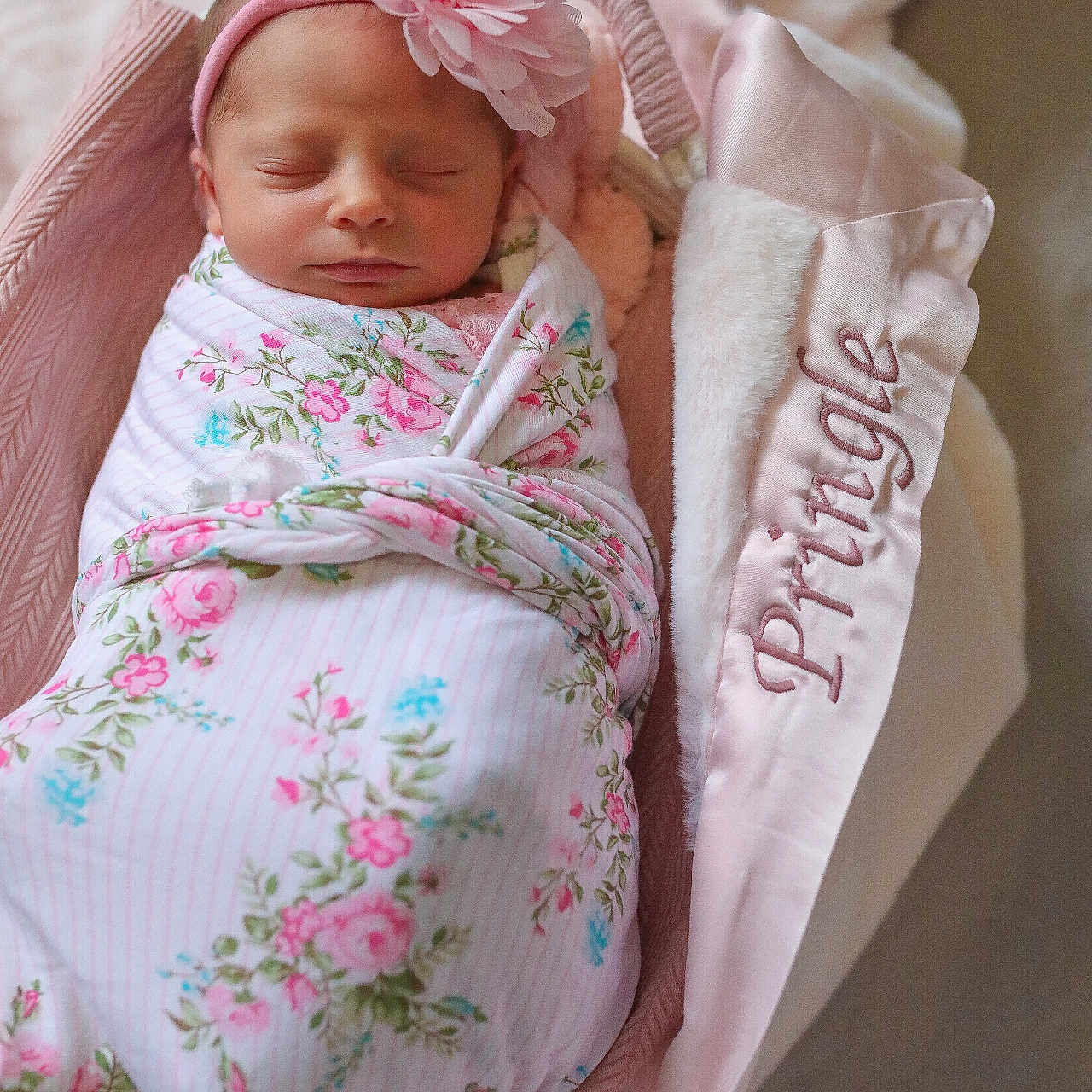 Elianna is registered to the contest to win money with this photo: newborn, baby, swaddled, flower_headband, sleeping, basket, blanket, pink, floral, cozy, soft, cute, infant, portrait, indoors, resting, peaceful, fabric, toddler, head