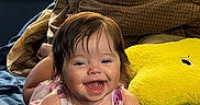 Emilia Rose joined the competition — help win amazing prizes! baby, bed, blanket, blue, brown, child, clothing, cozy, cute, face, hair, happy, indoor, infant, person, plush_pillow, smiling, toddler, window_blinds, yellow
