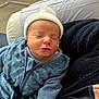 newborn, baby, sleeping, hat, blue_outfit, blanket, pillow, indoor, soft_texture, peaceful, infant, clothing, cozy, cute, resting, person, portrait, young_child, child, warm