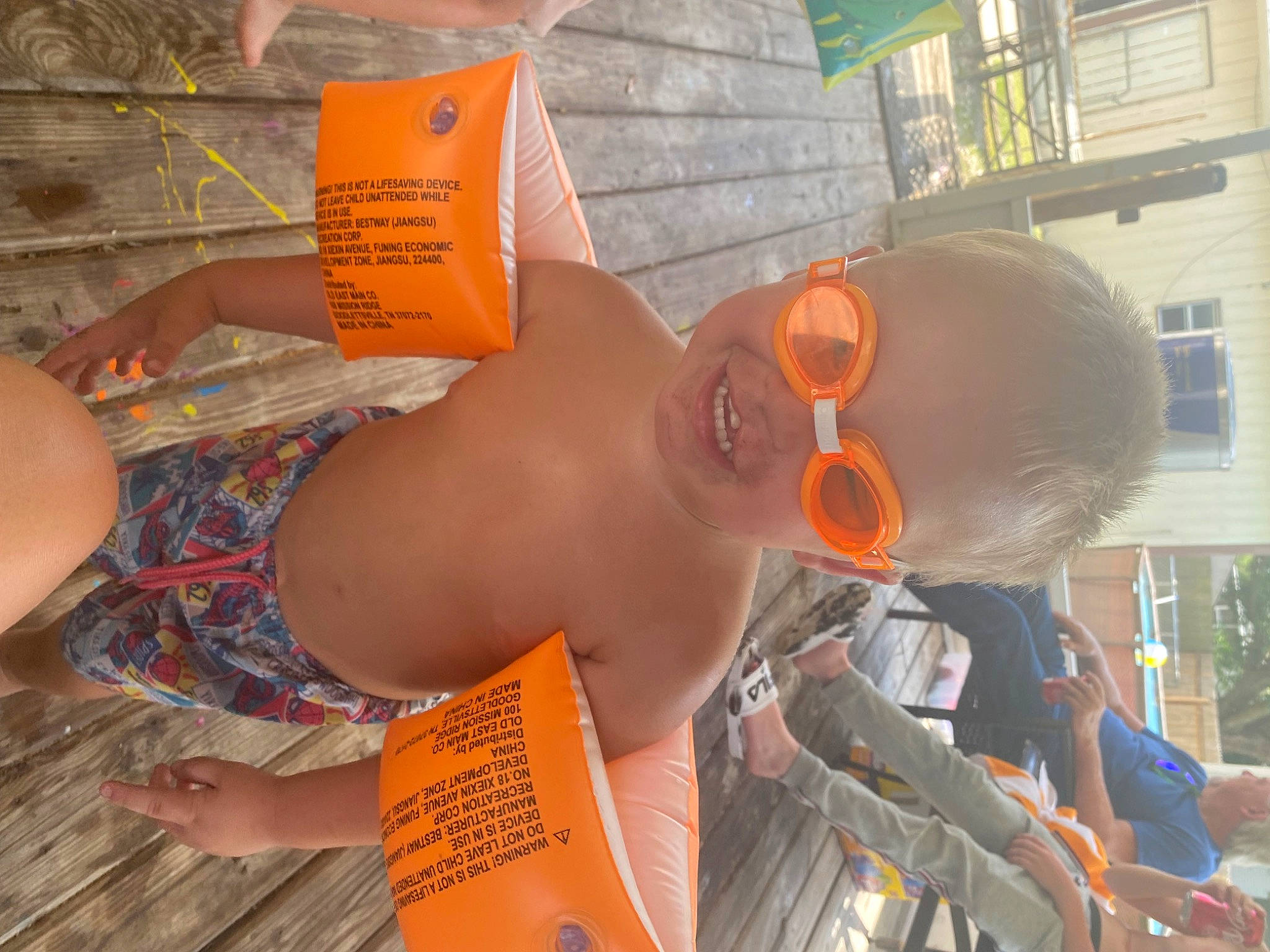 Branden is registered to the contest to win money with this photo: abdomen, barechested, chest, child, eyewear, fun, glasses, hat, headgear, human_leg, joy, leisure, orange, person, personal_protective_equipment, sunglasses, swimwear, thigh, trunk, vacation