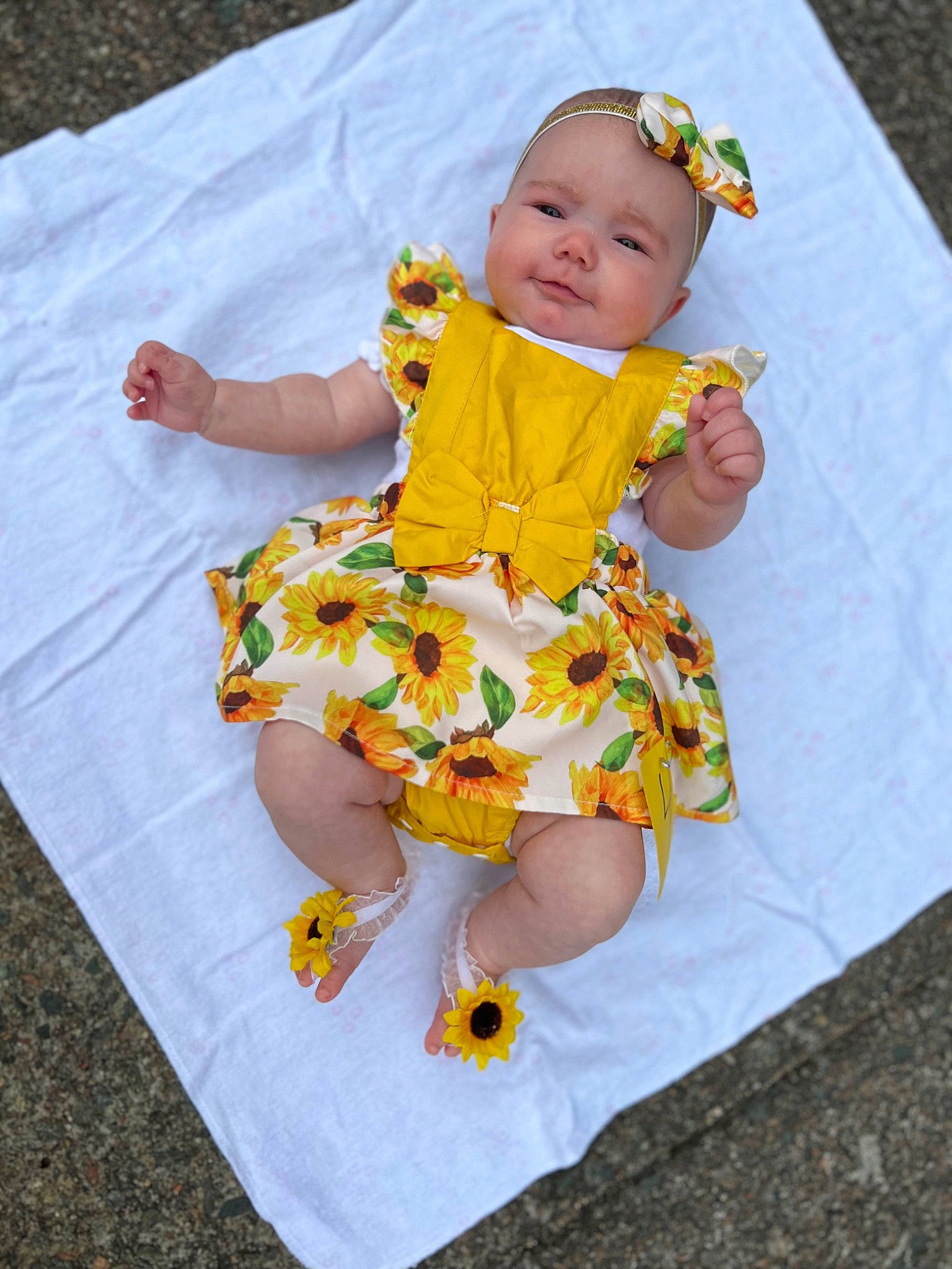 Jubilee is registered to the contest to win money with this photo: baby, baby_toddler_clothing, child, dress, eye, face, fun, grass, happy, head, headwear, leisure, linens, pattern, people_in_nature, person, skin, sleeve, smile, t_shirt