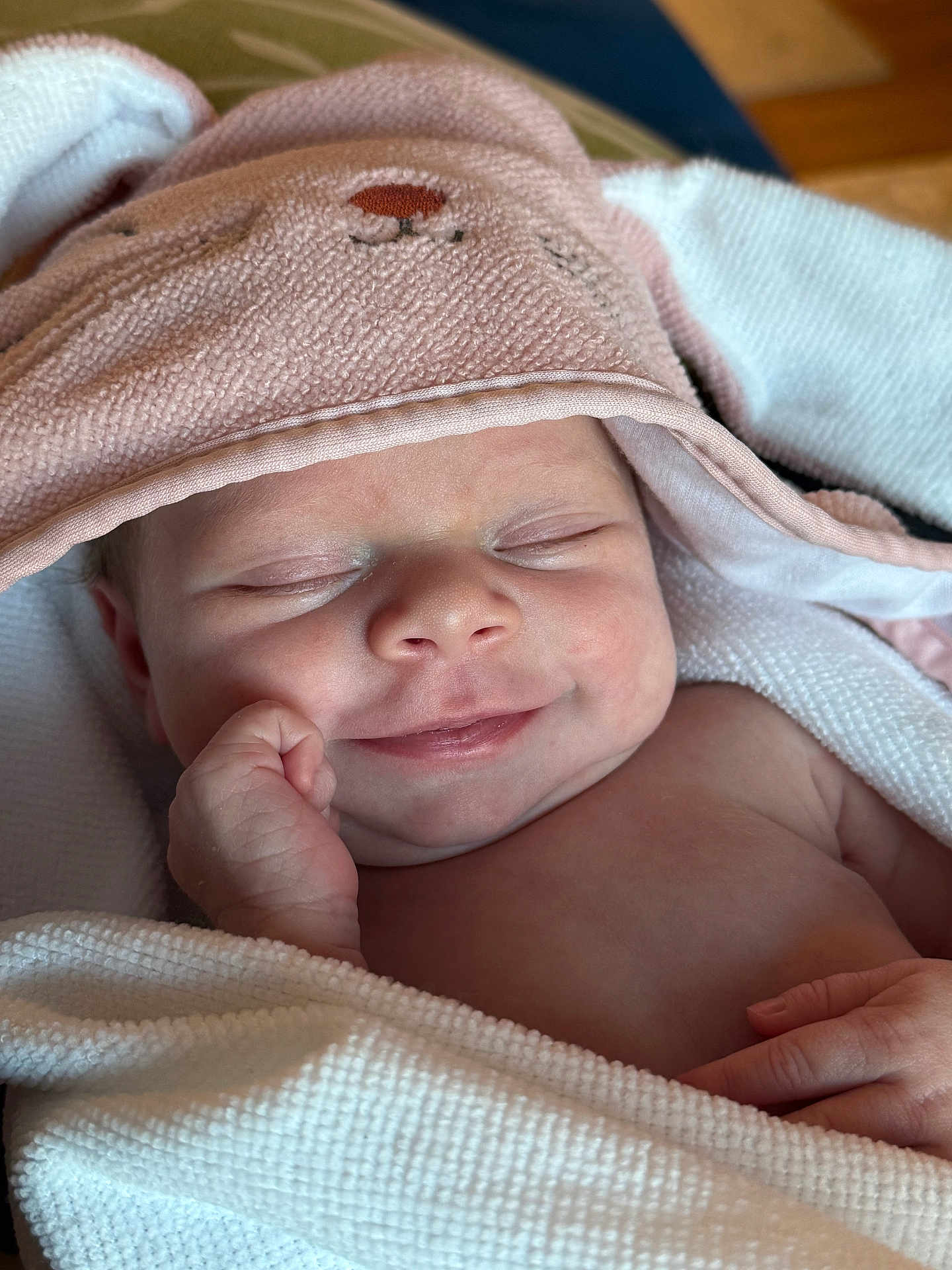 Sofia is registered to the contest to win money with this photo: baby, newborn, smile, sleeping, towel, hood, pink, white, skin, hand, cute, face, infant, cozy, wrapped, soft, peaceful, child, portrait, indoors