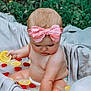 baby, child, pink_bow, headband, milk_bath, lemon_slices, raspberries, outdoor, nature, greenery, curious, sitting, skin, infant, soft_fabric, cute, summer, fresh, playful, toddler