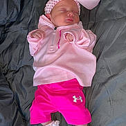 Ivy-Jayne is registered to the contest to win money with this photo: baby, newborn, sleeping, pink_clothing, headband, bow, socks, blanket, infant, child, cute, resting, soft_fabric, casual_wear, under_armour, indoor, portrait, small_hands, peaceful, cozy