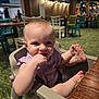 Keira joined the competition — help win amazing prizes! baby, blond_hair, carpet, casual, chair, child, face, foot, furniture, hand, happy, high_chair, indoor, lighting, person, purple_clothing, restaurant, skin, smiling, table