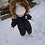 boots, child, cold_weather, curious, exploring, footprints, fur_hood, hat, mittens, outdoor, person, playful, puffer_jacket, snow, snowy_ground, standing, toddler, white_snow, winter, winter_clothing