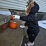Keira joined the competition — help win amazing prizes! building_wall, child, cold_weather, concrete, curb, curious, exploring, fall, footwear, gloves, hood, outdoor, person, pumpkin, seasonal, side_view, snow, snowsuit, toddler, winter_clothing
