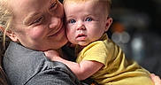 Aliyah joined the competition — help win amazing prizes! baby, adult, hug, love, affection, portrait, indoor, yellow_clothing, smile, curious, tattoo, short_hair, candid, family, child, person, closeup, comfort, casual, warmth
