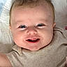Aliyah is registered to the contest to win money with this photo: baby, smiling, face, child, infant, happy, cute, lying_down, blanket, clothing, portrait, skin, head, eyes, mouth, cheeks, indoors, toddler, person, baby_girl