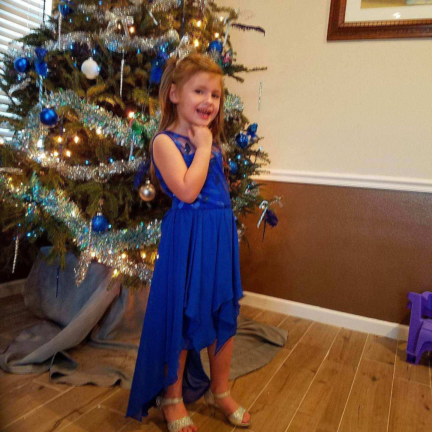 Claire is registered to the contest to win money with this photo: blue, child, christmas, christmas_decoration, christmas_eve, christmas_ornament, christmas_tree, cobalt_blue, costume, dance, dress, electric_blue, event, formal_wear, holiday, interior_design, joy, long_hair, person, smile