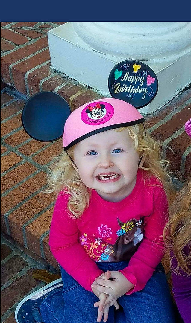 Kate is registered to the contest to win money with this photo: cap, cheek, child, cool, day, facial_expression, fun, girl, hair_accessory, head, headgear, headwear, human_hair_color, joy, magenta, party_hat, person, pink, product, purple