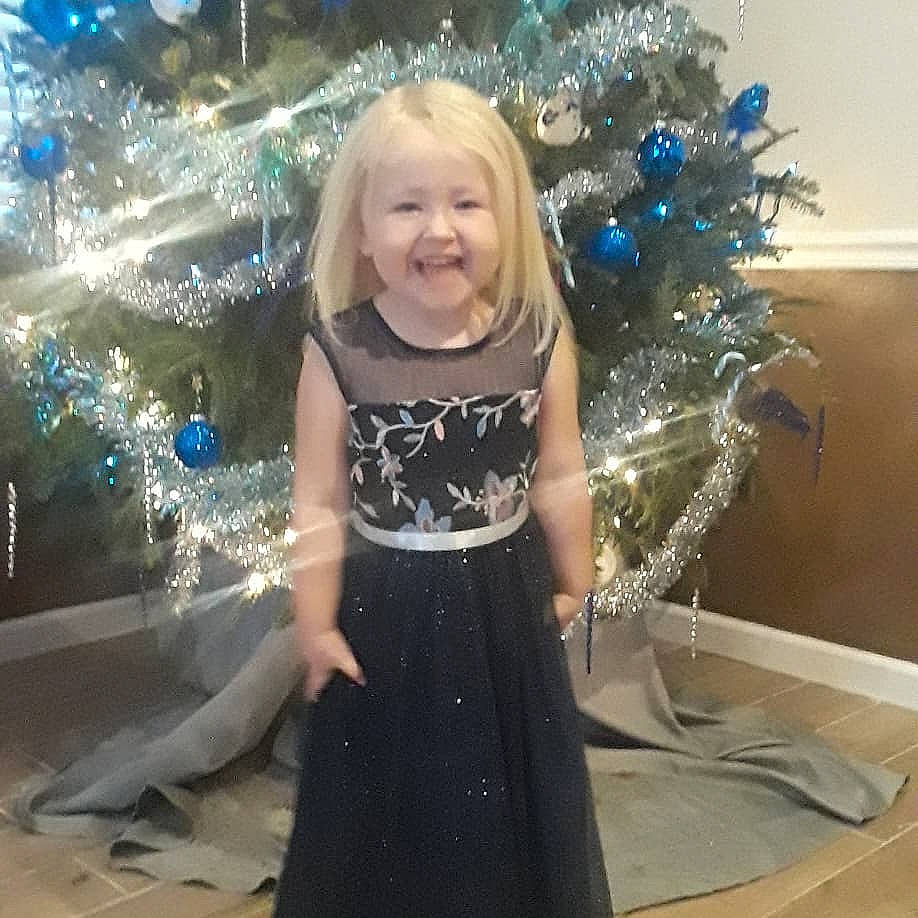 Kate is registered to the contest to win money with this photo: child, christmas, christmas_decoration, christmas_eve, christmas_tree, dress, fun, interior_design, joy, person, smile, toddler, tree