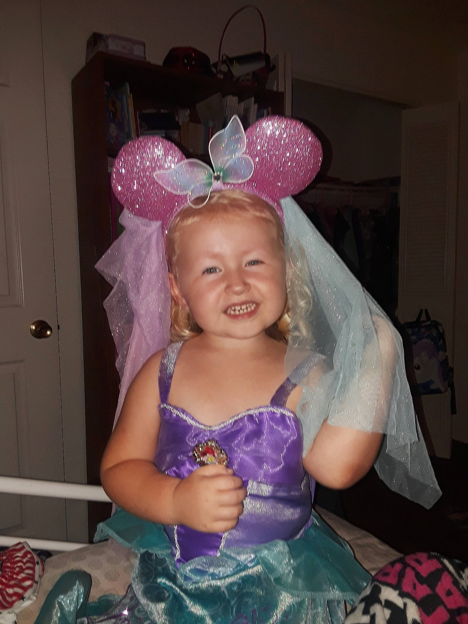 Kate is registered to the contest to win money with this photo: child, costume, fashion_accessory, fun, girl, hair_accessory, headgear, headpiece, human_hair_color, infant, iris, joy, party_hat, person, pink, product, purple, smile, textile, toddler